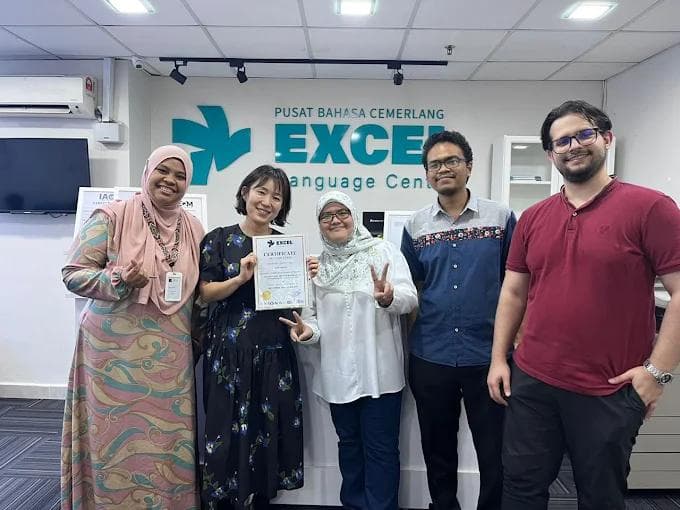 Staff and student celebrating certificate completion