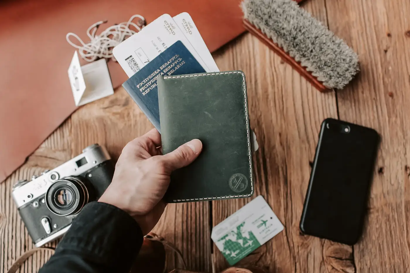 A passport, phone and travel documents ready on a table