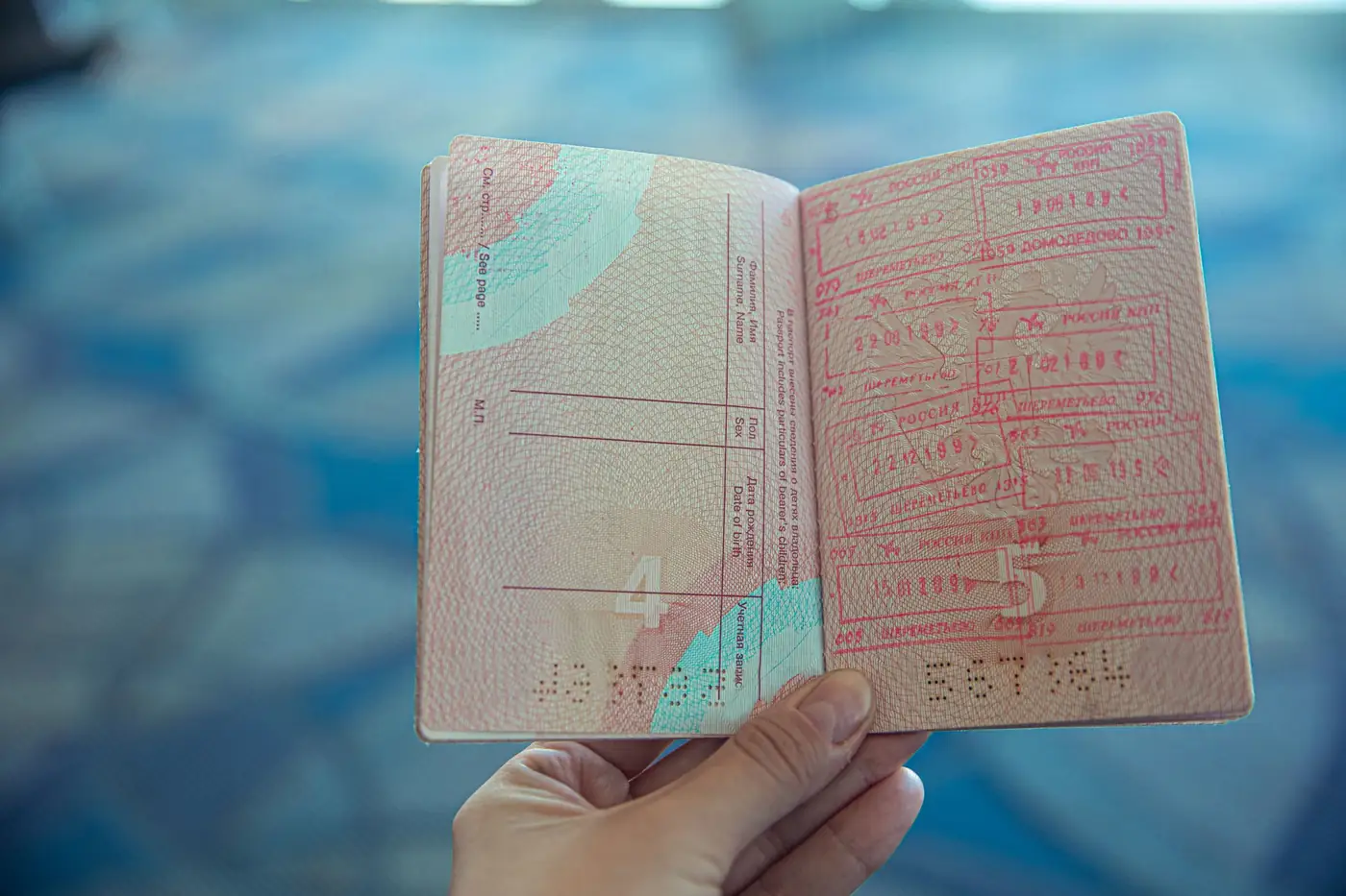 An open passport with entry stamps